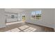 Open-concept living area with bright windows and access to the kitchen and outdoor space at 832 Canis Minor Rd, Wendell, NC 27591