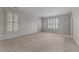 Spacious bedroom featuring neutral walls, carpet flooring, and bright windows at 100 Edenburgh Rd # 202, Raleigh, NC 27608