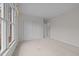 Bedroom with neutral walls, carpet, a closet, and windows offering natural light at 100 Edenburgh Rd # 202, Raleigh, NC 27608