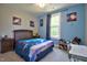 Cozy bedroom featuring blue walls, natural light and a decorative space theme at 1012 Cook Rd, Durham, NC 27713