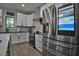 Modern kitchen boasts stainless steel appliances, white cabinets, and sleek countertops at 1012 Cook Rd, Durham, NC 27713