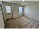 Bright bedroom featuring neutral carpet, with two windows providing natural light at 10523 Brookside Reserve Rd, Raleigh, NC 27614