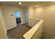 Hallway featuring neutral carpet, with views into a bathroom and bedroom at 10523 Brookside Reserve Rd, Raleigh, NC 27614