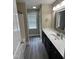 Modern bathroom with vanity, new countertops, and neutral walls and wood look flooring at 106 Bishop Ln, Dunn, NC 28334