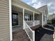 Inviting front porch with brick steps, white railings, and fresh landscaping at 106 Bishop Ln, Dunn, NC 28334