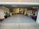 Spacious two car garage with shelving on the back wall and epoxy flooring at 106 Bishop Ln, Dunn, NC 28334