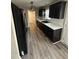 Modern kitchen featuring dark cabinetry, white countertops, a black fridge, and wood-look floors at 106 Bishop Ln, Dunn, NC 28334