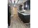 Stylish kitchen featuring dark cabinets, modern white countertops, and stainless steel appliances at 106 Bishop Ln, Dunn, NC 28334