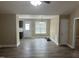 Bright, open-plan living room with wood-look floors, neutral walls, and access to the kitchen at 106 Bishop Ln, Dunn, NC 28334