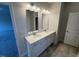 Bright bathroom featuring double vanities, ample lighting, and tile flooring at 106 E Victory View. Ter, Smithfield, NC 27577