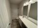 Well-lit bathroom with double mirrors, updated countertop, and neutral-colored shower at 106 E Victory View. Ter, Smithfield, NC 27577