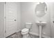 Bathroom with a pedestal sink and tile flooring, features a white door to match the trim at 106 E Victory View. Ter, Smithfield, NC 27577