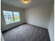 Bright bedroom features a large window, soft carpet, and neutral wall paint at 106 E Victory View. Ter, Smithfield, NC 27577