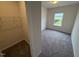 Carpeted bedroom with a walk-in closet and bright window at 106 E Victory View. Ter, Smithfield, NC 27577