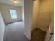 Cozy bedroom and closet area featuring soft carpet, a window, and closet access at 106 E Victory View. Ter, Smithfield, NC 27577