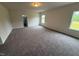 Bright carpeted bedroom with natural light streaming in from the large windows at 106 E Victory View. Ter, Smithfield, NC 27577
