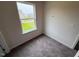 Cozy bedroom with plush carpeting and a large window offering scenic views at 106 E Victory View. Ter, Smithfield, NC 27577
