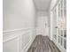 Hallway featuring hardwood floors, decorative trim and a glass french door leading into another room at 106 E Victory View. Ter, Smithfield, NC 27577