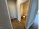 Hallway with wood floors leading to a bathroom at 106 E Victory View. Ter, Smithfield, NC 27577