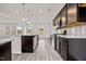Modern kitchen featuring stainless steel appliances, dark cabinets, and an island with pendant lights at 106 E Victory View. Ter, Smithfield, NC 27577