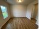 Bright living room featuring hardwood floors and a large window overlooking the yard at 106 E Victory View. Ter, Smithfield, NC 27577