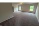 Spacious carpeted living room filled with natural light from the multiple bright windows at 106 E Victory View. Ter, Smithfield, NC 27577