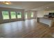 Open-concept living space featuring hardwood floors, kitchen with island and large windows at 106 E Victory View. Ter, Smithfield, NC 27577