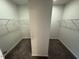 Large walk-in closet with ample shelving and carpeting, ready for storage and organization at 106 E Victory View. Ter, Smithfield, NC 27577