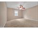 Carpeted bedroom with a ceiling fan, light beige walls, and a window for natural light at 1079 Vauxhall Dr, Apex, NC 27502