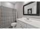 Bathroom featuring a vanity with a white countertop, a mirror, a toilet, and a shower with a striped curtain at 109 Beldenshire Way, Holly Springs, NC 27540