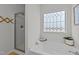 Bright bathroom featuring a soaking tub with a stained glass window and a separate glass shower at 115 Rocky Branch Ct, Garner, NC 27529