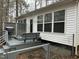 Back exterior with a gray porch, white siding, and well-maintained landscaping at 117 Lone Star Dr, Louisburg, NC 27549