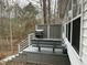 Cozy back porch featuring a bench, grill, and lattice privacy screen at 117 Lone Star Dr, Louisburg, NC 27549