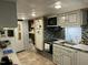 Well-equipped kitchen featuring white cabinets, stainless steel appliances, and a unique backsplash design at 117 Lone Star Dr, Louisburg, NC 27549