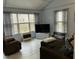 Spacious living room with plenty of windows, comfortable seating, and a large television for relaxation at 117 Lone Star Dr, Louisburg, NC 27549