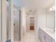 Bathroom view showcasing a vanity with a large mirror, glass-enclosed shower, and walk-in closet at 1229 Dimaggio Dr # 8, Raleigh, NC 27616