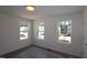 Bright bedroom with three windows offering natural light and views of the neighborhood at 1229 Dimaggio Dr # 8, Raleigh, NC 27616