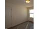 Bedroom featuring a door, neutral-toned walls, carpeted floor and a sunny window at 1229 Dimaggio Dr # 8, Raleigh, NC 27616