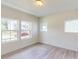 Bright bedroom featuring three windows letting in natural light and views of the neighborhood at 1229 Dimaggio Dr # 8, Raleigh, NC 27616