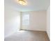 Neutral bedroom features a window and neutral carpeting at 1229 Dimaggio Dr # 8, Raleigh, NC 27616