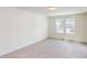 Bedroom featuring plush carpet, white trim, and natural light from two windows at 1229 Dimaggio Dr # 8, Raleigh, NC 27616