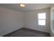 Cozy bedroom featuring neutral walls, carpet, and a window for ample natural light at 1229 Dimaggio Dr # 8, Raleigh, NC 27616