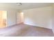 Bright bedroom features neutral carpeting and paint with a door leading to an ensuite bathroom at 1229 Dimaggio Dr # 8, Raleigh, NC 27616