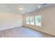 Bedroom showcasing hardwood floors, recessed lighting, and three large windows providing ample natural light at 1229 Dimaggio Dr # 8, Raleigh, NC 27616