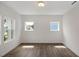 Bright bedroom with hardwood floors and natural light from three windows at 1229 Dimaggio Dr # 8, Raleigh, NC 27616