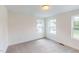 Well-lit bedroom features carpet and a window at 1229 Dimaggio Dr # 8, Raleigh, NC 27616