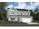 Two-story home featuring gray siding, a two-car garage, and a well-manicured lawn at 1229 Dimaggio Dr # 8, Raleigh, NC 27616