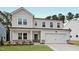 Charming two-story home with white siding, stone accents and a two car garage at 1229 Dimaggio Dr # 8, Raleigh, NC 27616