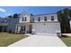 Charming two-story home featuring a covered porch and a two-car garage, landscaped yard and a bright exterior at 1229 Dimaggio Dr # 8, Raleigh, NC 27616
