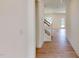Hallway showcasing hardwood floors, recessed lighting, a staircase, and access to an outdoor patio at 1229 Dimaggio Dr # 8, Raleigh, NC 27616